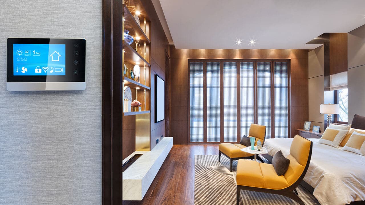 A smart device is installed on the entryway of a luxurious bedroom.